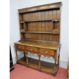 Dark Oak Dresser, in the Titchmarsh and Goodwin manner, with two pigeon holed drawers to planked