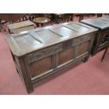 A XVIII Century Oak Coffer, with four panelled top, half wheel carving over three panels to