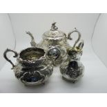A Highly Decorative Plated Three Piece Tea Set, profusely detailed in relief, the tea pot with