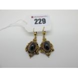 A Pair of 9ct Gold Victorian Style Earpendants, each of shaped design, oval cabochon collet set to