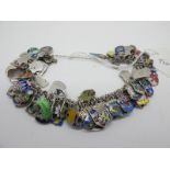 A Souvenir Charm Bracelet, suspending numerous enamel shield charm pendants.