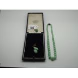 A Pair of Polished Green Hardstone Drop Earrings, on chain suspension and unpierced screw fitting,