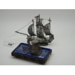 A Miniature Filigree Model of A Galleon, at full sail, on oval filigree base, overall height 11.5cm;