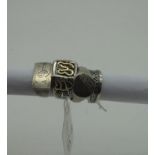 A Middle Eastern Style Gent's Ring, the rectangular panel between tapered shoulders, of abstract