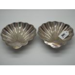 A Pair of Hallmarked Silver Shell Dishes, GH, Sheffield 1910, raised on three ball feet,