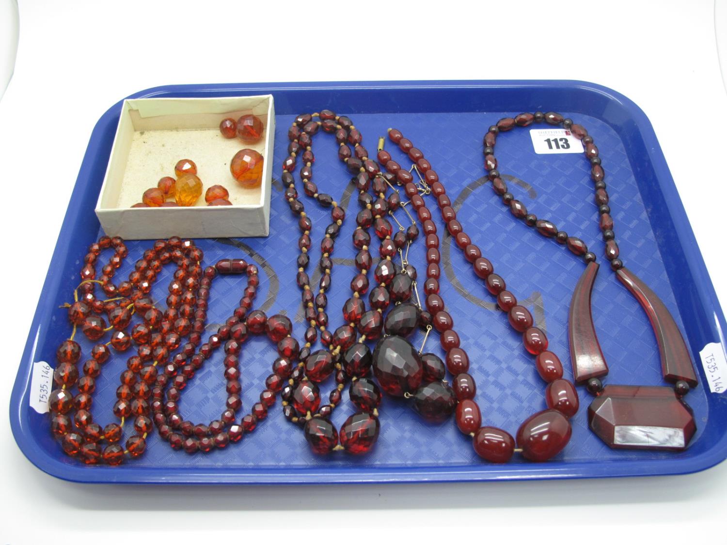 Cherry Amber Coloured Bead Necklaces, (one string broken/loose beads):- One Tray
