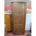 An Oak Hall Wardrobe, with cantered corners and linen fold to door, 80.5cm wide.