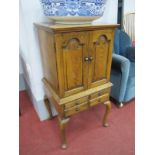 A Small Oak Chest on Stand, the top with moulded edge over twin panelled doors, eight internal