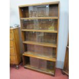 Minty of Oxford, five sectional walnut bookcase, with sliding glazed doors, 23cm deep, the lower