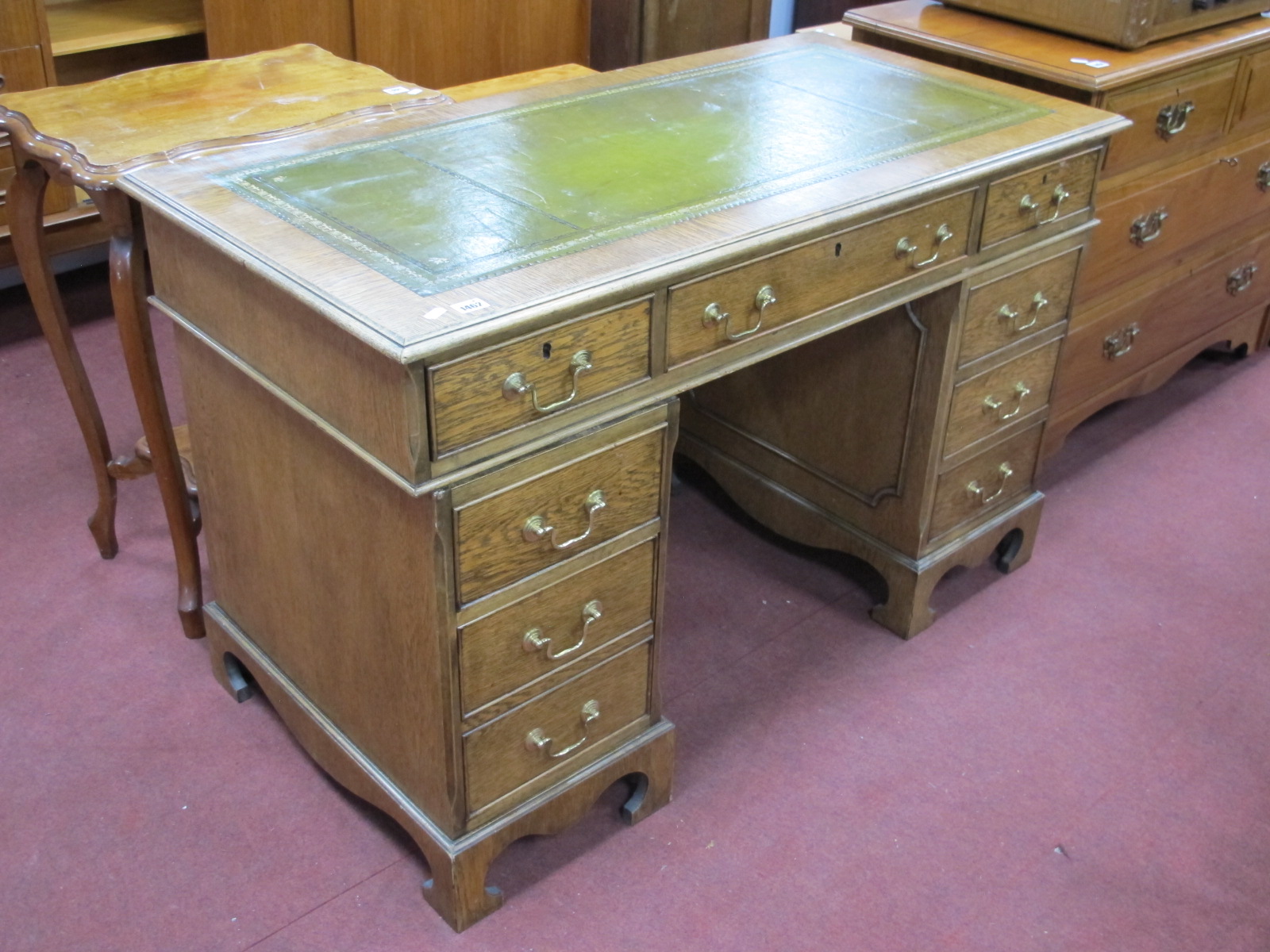 Twin Pedestal Desk, with green leather inset top, swan neck handles to eight drawers.