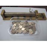 A 20p Coin Saver (containing £25), with lock and key; together with £25.60 in 20p coins.