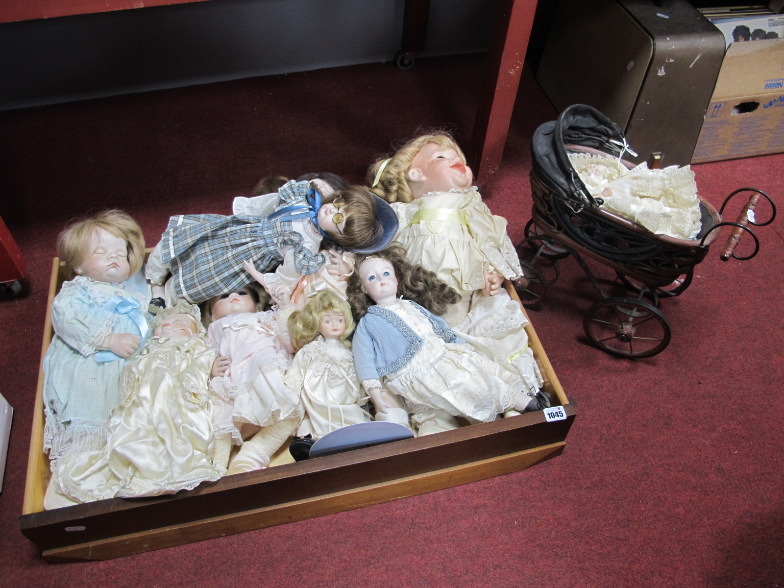 Eight Modern Porcelain Collectors Dolls; plus a small porcelain doll in antique style pushchair. (