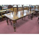 A Late XIX Century Walnut Extending Dining Table, with wind out action, canted corners, on turned