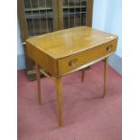 An Ercol Blonde Side Table, with oval protruding handled to single drawer, on tapering legs united