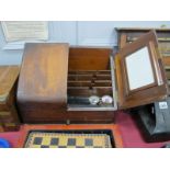 An Early XX Century Oak Stationary Box, with twin doors to slope front, concealing fitted