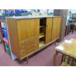 A Dalescraft Teak Tall Sideboard, having fall front cupboard over four drawers, sliding cupboard