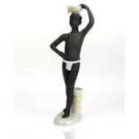 A SOVIET PORCELAIN FIGURE OF AN AFRICAN WATER CARRIER, LOMONOSOV STATE PORCELAIN FACTORY, LENINGRAD