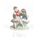 A SOVIET PORCELAIN FIGURAL PAIR OF GIRLS ON A BENCH, ARTEL CERAMIC OR GORODNITSKY PORCELAIN FACTORY