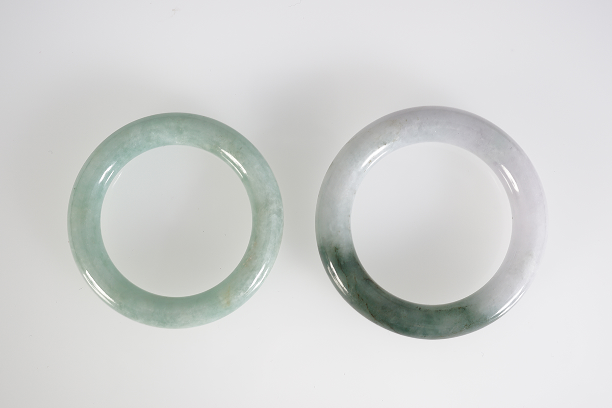 TWO SMALL CELADON JADE BANGLES