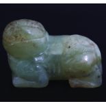 TWO EARLY CHINESE CELADON JADE RECUMBENT FOO DOGS