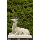 PORTLAND STONE SCULPTURE OF A SEATED STAG