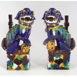 PAIR OF CHINESE POLYCHROME STONEWARE FO DOGS