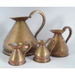 FOUR GRADUATED COPPER MEASURING JUGS