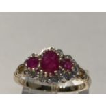 9 CT YELLOW GOLD 3 STONE RUBY AND DIAMOND CLUSTER