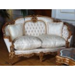 PAIR OF CARVED AND PARCEL GILT SETTEES