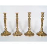 SUITE OF 4 ANTIQUE BRASS CANDLESTICKS