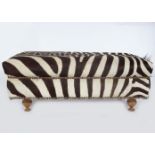 DESIGNER HIDE UPHOLSTERED OTTOMAN