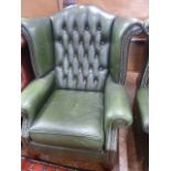 Green leather buttoned wing back armchair