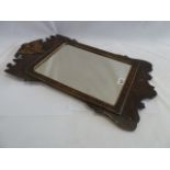 Regency style walnut wall mirror with carved golden eagle motif in pediment