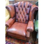 Red leather buttoned wing back armchair