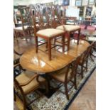 Regency style oval extending dining table & a set of 6 mahogany Chipendale style chairs