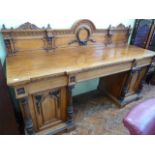 Victorian honey oak pedestal sideboard with reeded column door pulls and carved back