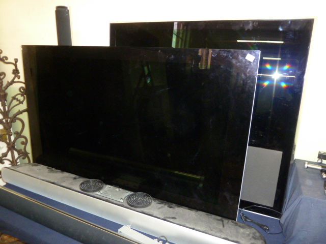 2 Bang and Olufsen Beo-vision televisions, surround sound speakers and remote controls etc NB,