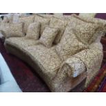 Curved 4 seater sofa upholstered in gold and red classic foliate design fabric