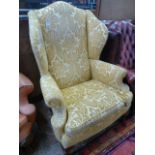 Gold cut velvet wing back armchair