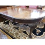 Victorian carved mahogany telescopic oval dining table on ball and claw feet