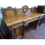 Victorian honey oak pedestal sideboard with reeded column door pulls and carved back