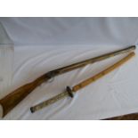 Replica Samurai sword with scrimshaw style handle in wooden scabbard and replica flinlock rifle
