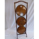 Edwardian mahogany and figured walnut folding cake stand