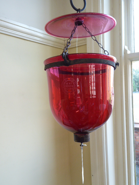 19thC Cranberry glass hanging bell jar lantern suspended on 3 chain hooks with pheasants head