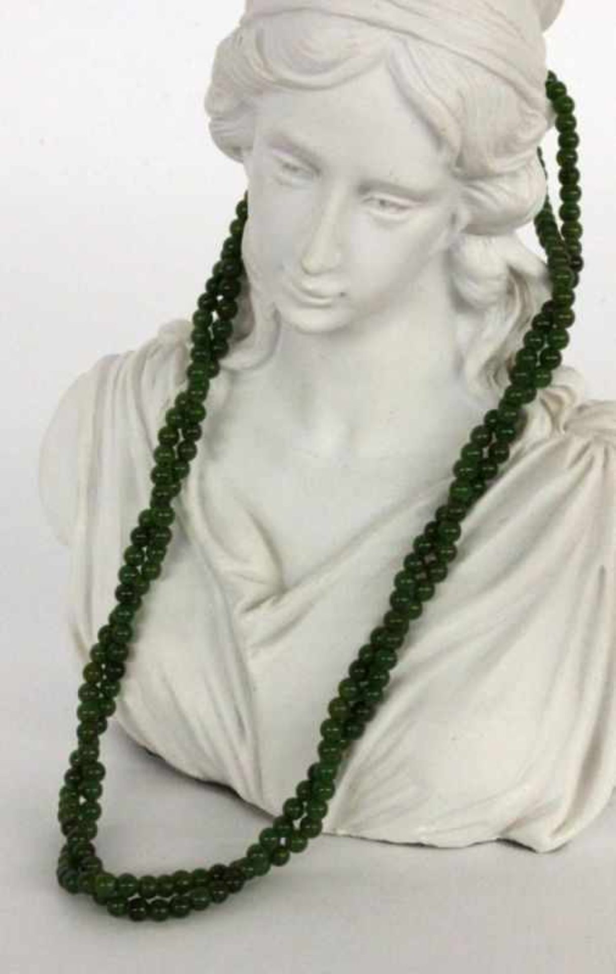 ''A NECKLACE WITH JADE BEADS 2 strands. 40 cm long, clasp giltKeywords: jewellery,