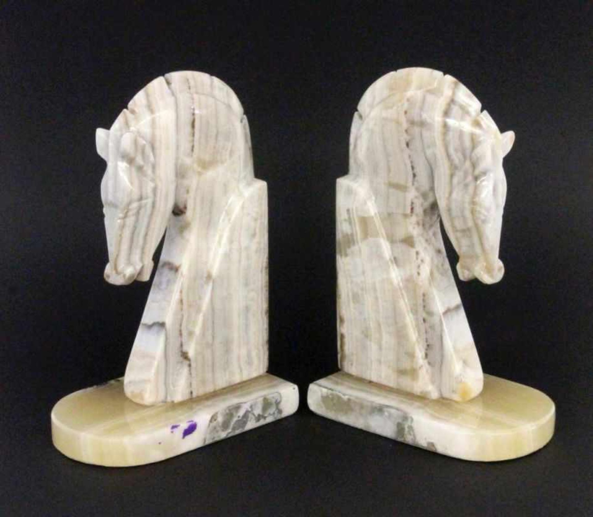 A PAIR OF ART DECO BOOKENDS Stylised marble horse busts. 23 cm high
