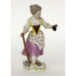 ''GIRL WITH GRAPES Meissen, 20th century Colourfully decorated child figure. Blue crossed