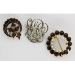 ''TWO GARNET BROOCHES Includes an Art Nouveau brooch with small pearls. Condition: some