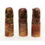 ''THREE FIGURES OF GODS China. Probably red marble. Cut figures and engraved decoration.