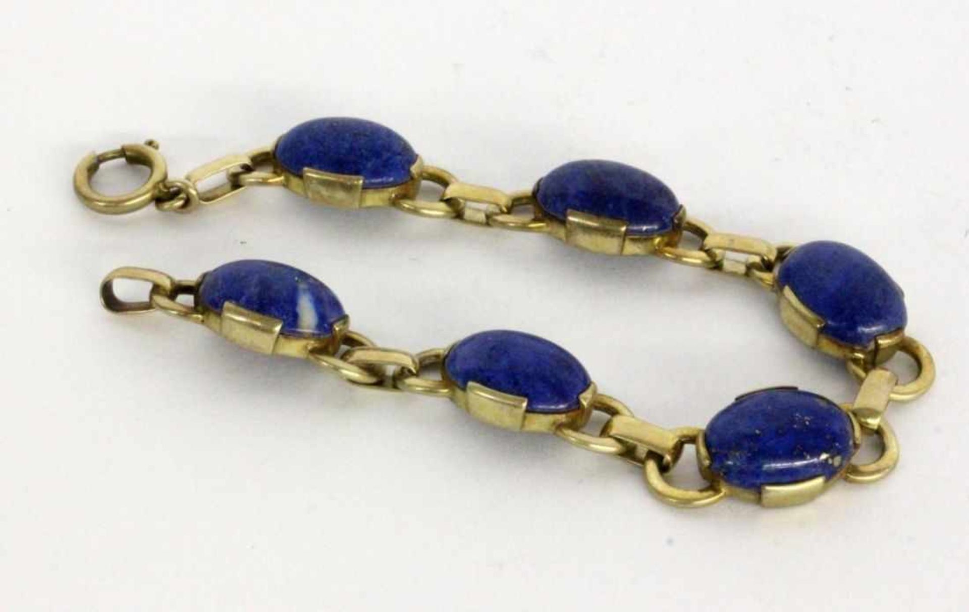 ''A BRACELET Silver gilt with lapis lazuli cabochons. 18.5 cm longKeywords: jewellery,